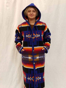 Long wool coat, sapphire blue with red, orange and back geometric accents in the Chief Joseph pattern.