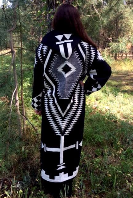 Long wool coat, black with white and grey geometric pattern accents.