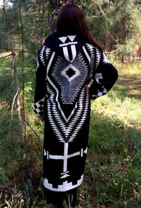 Long wool coat, black with white and grey geometric pattern accents.