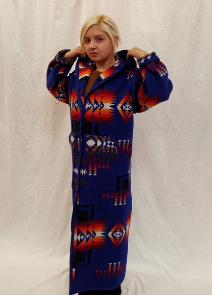 Long wool coat, sapphire blue with red, orange and back geometric accents in the Chief Joseph pattern.