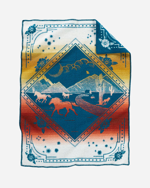 Pendleton wool blue baby blanket, with red and yellow accents and running horses in a mountain desert scene.