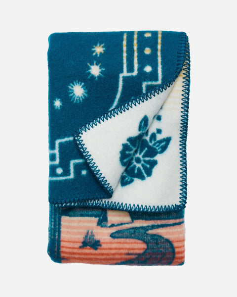 Pendleton wool blue baby blanket, with red and yellow accents and running horses in a mountain desert scene.