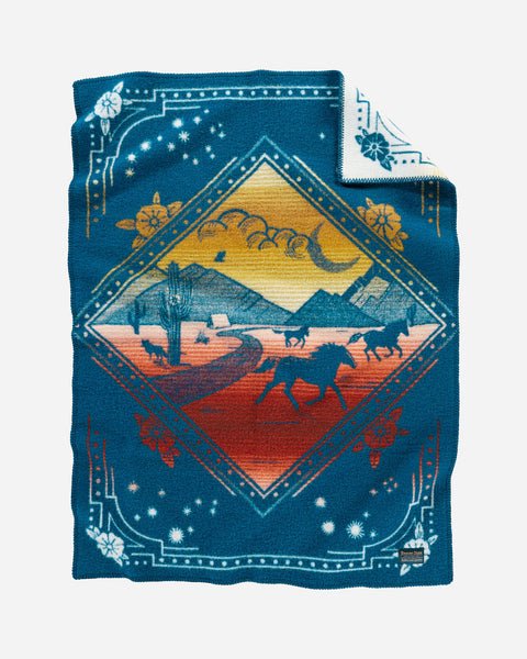 Pendleton wool blue baby blanket, with red and yellow accents and running horses in a mountain desert scene.