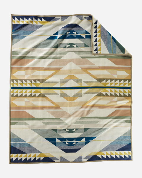 Pendleton wool blanket, patterned geometric shapes in earth tones and blues, named Fossil Springs.