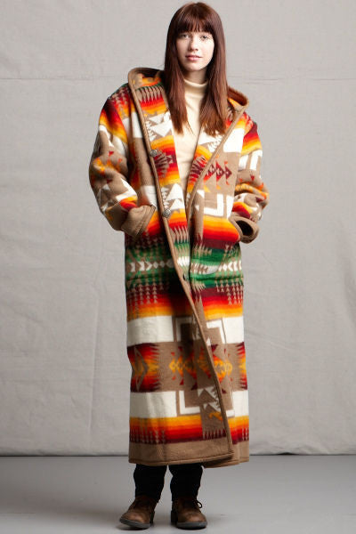 Long wool coat, khaki-brown, with ivory, red and orange geometric accents in Chief Joseph pattern by Pendleton.